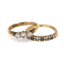 A 9ct gold ring with three small claw set graduated diamonds and a 9ct gold half eternity diamond