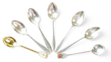 Seven hallmarked silver spoons comprising five matching coffee spoons, a silver gilt souvenir