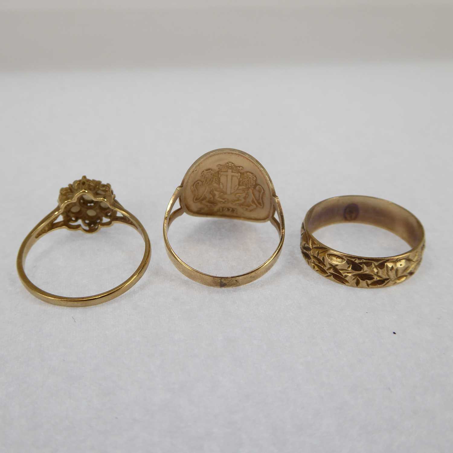 Three 9ct gold rings comprising a seed pearl flower cluster, size M, a 9ct band with textured - Image 3 of 3