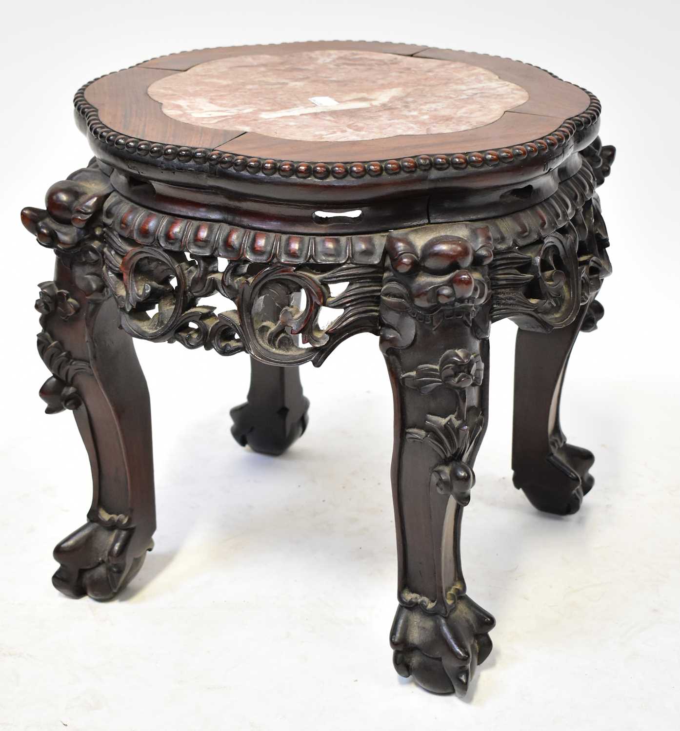 A small Chinese hardwood carved plant stand with inset rouge marble panel to the top, above a