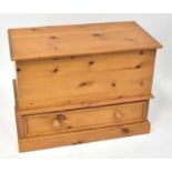 A modern waxed pine blanket box with lift-up top above a cupboard drawer, on a plinth base, 69 x