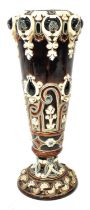 A Majolica vase of tapering form to spreading foot with embossed floral decoration, height 37cm.