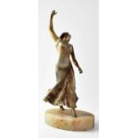 A painted bronze sculpture of a female dancer, raised on an oval hardstone plinth, unsigned,