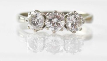 An 18ct white gold three-diamond ring, the central diamond approx. 0.5ct, flanked by a pair of