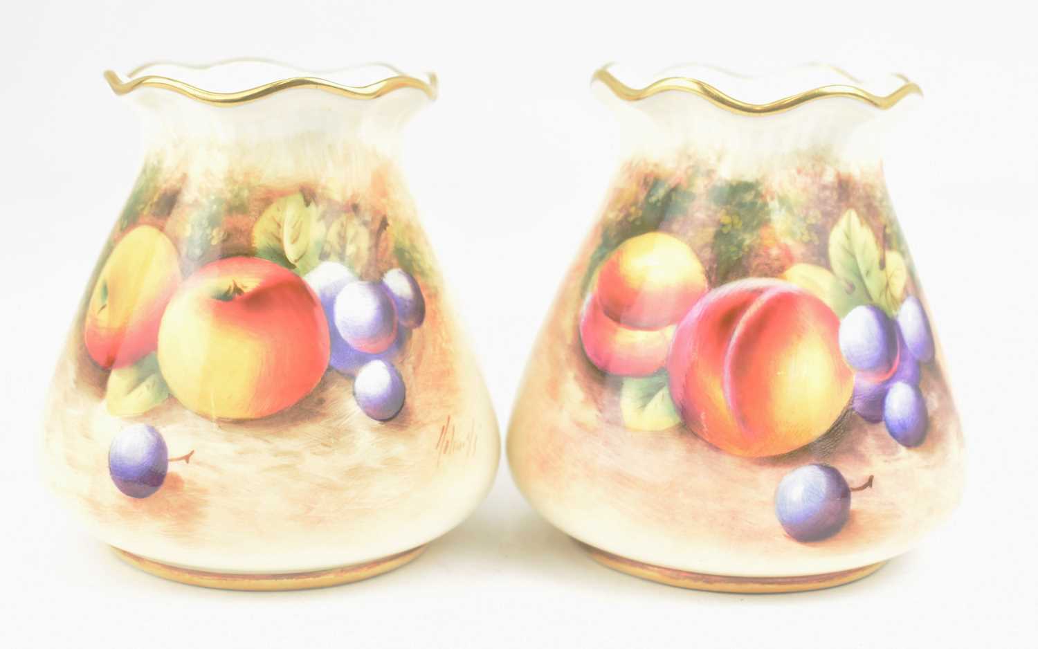 ROYAL WORCESTER; two small porcelain vases, both hand painted with a similar 'Fallen Fruit' design
