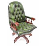 A modern reproduction swivel office chair with green leather button back and seat. Condition Report: