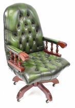 A modern reproduction swivel office chair with green leather button back and seat. Condition Report: