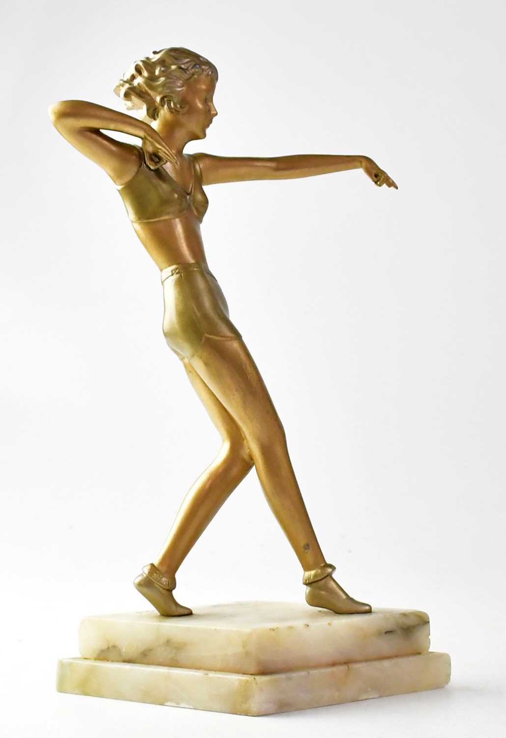 AFTER JOSEF LORENZL (1892-1950); a painted spelter figure of an Art Deco flapper girl, raised on