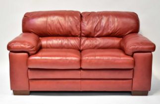 A modern red leather two-seater sofa with stitched detail, 92 x 165 x 96cm.