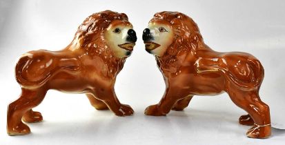 STAFFORDSHIRE; a pair of lions with applied glass eyes, unmarked, height 27cm (2). Condition Report: