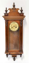 A mahogany cased spring-driven Vienna-style wall clock with twin drum movement striking on a gong,
