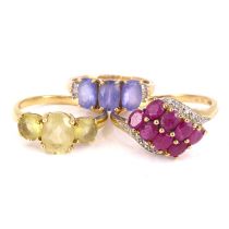 Three 9ct yellow gold dress rings to include a ruby and tiny diamond chip crossover ring, size S,
