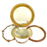 Four wall mirrors, comprising an oval example with bevelled edge, length 45cm, a circular mirror