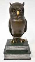 MANGREB; a bronze figure of an owl on two books with applied foundry token for Austria Bronze verso,