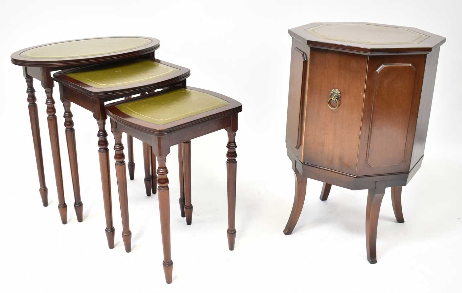 A reproduction mahogany drinks cabinet in the form a cellarette with octagonal green leather inset