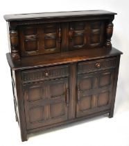 ERCOL; a dark stained elm court cupboard, 127 x 121.5 x 46cm.