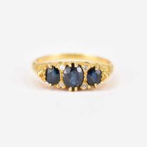 An 18ct gold sapphire and diamond ring in a typical Victorian-style mount, the three graduated