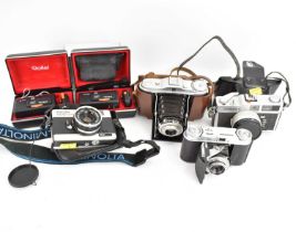 Six vintage cameras comprising two cased Rollei A110, an Agfa Agnar, 1:4, 5/85 Vario, in leather