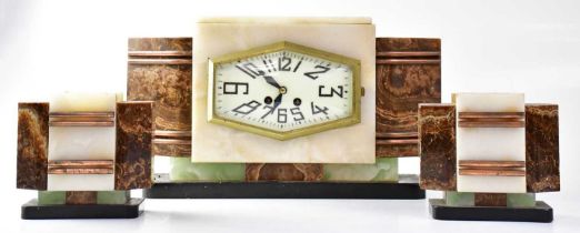 A French Art Deco eight-day mantel clock garniture, the hexagonal dial set with Arabic numerals,