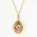 A 9ct gold oval double locket set with central ruby and diamond, on a 9ct gold belcher link chain,