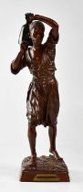 AFTER LOUIS AUGUSTE HIOLIN; a bronze figure of a Moorish water carrier holding a water jar on his