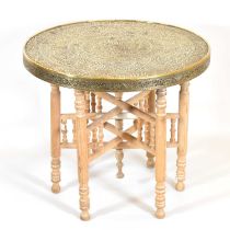 An early 20th century brass tray-top table on folding stand, diameter 60cm, height 52cm.