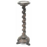 A substantial carved mahogany plant stand with dished top above a border of vines, with