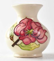 MOORCROFT; a 'Magnolia' pattern squat vase with cream ground, impressed green marks, height 9cm.