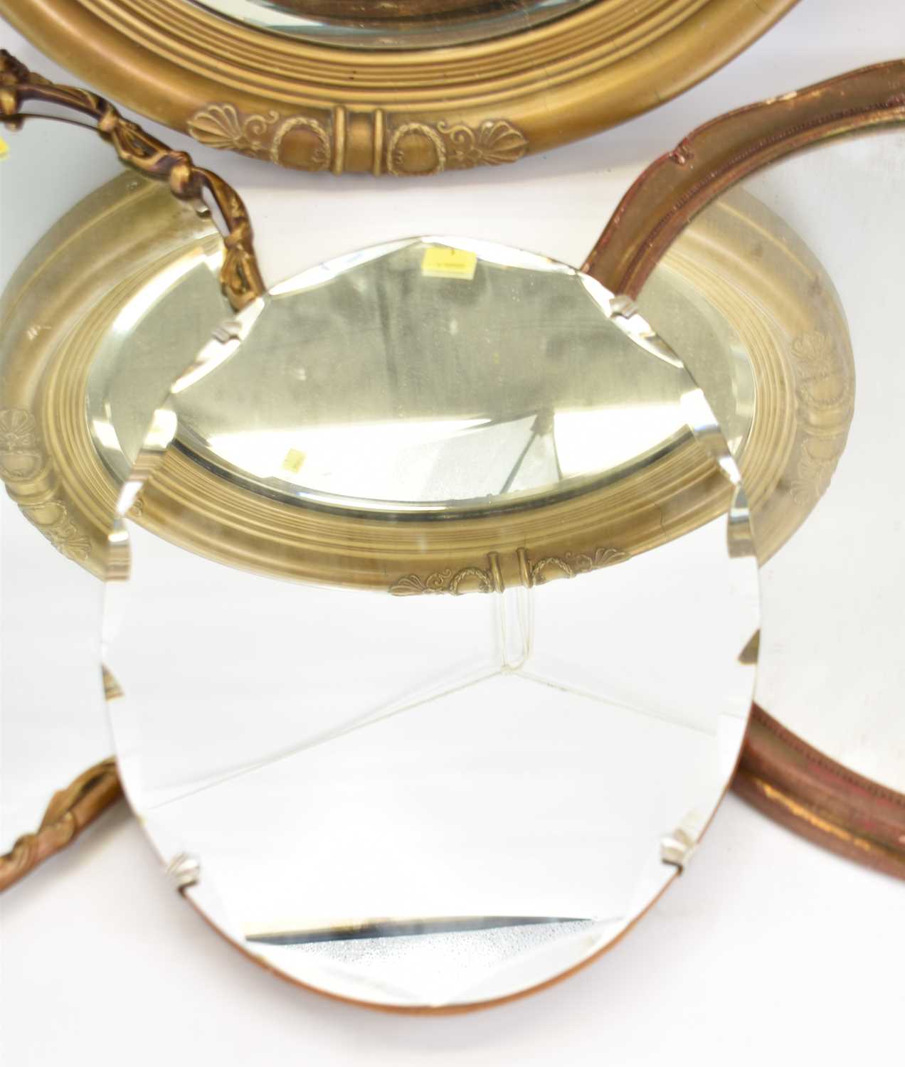 Four wall mirrors, comprising an oval example with bevelled edge, length 45cm, a circular mirror - Image 3 of 5