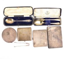 Hallmarked silver items comprising three cigarette cases, small sugar tongs, a Christening spoon and