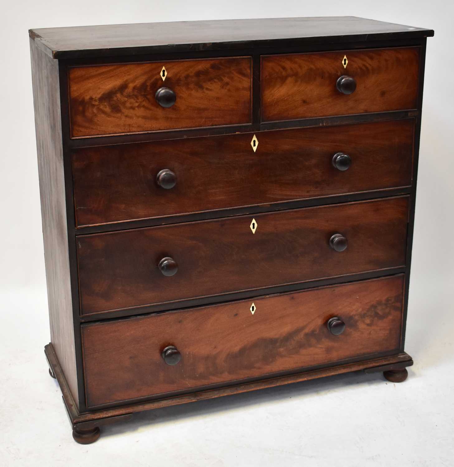 A Victorian mahogany crossbanded chest of two short over three long graduated drawers, raised on bun