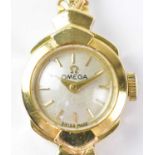 OMEGA; an 18ct gold ladies' wristwatch, the circular silvered dial set with baton numerals, diameter