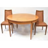 G-PLAN; a circular extending dining table, diameter 128cm (173cm when extended), with six faux