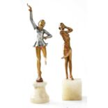 A pair of Art Deco style painted spelter figures of young ladies, raised on hardstone plinths, one