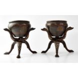 A pair of Eastern bronze bowls with incised decoration, raised on bone inlaid folding stands, height
