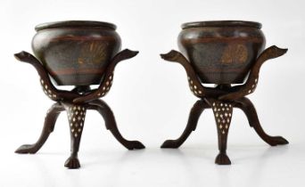 A pair of Eastern bronze bowls with incised decoration, raised on bone inlaid folding stands, height