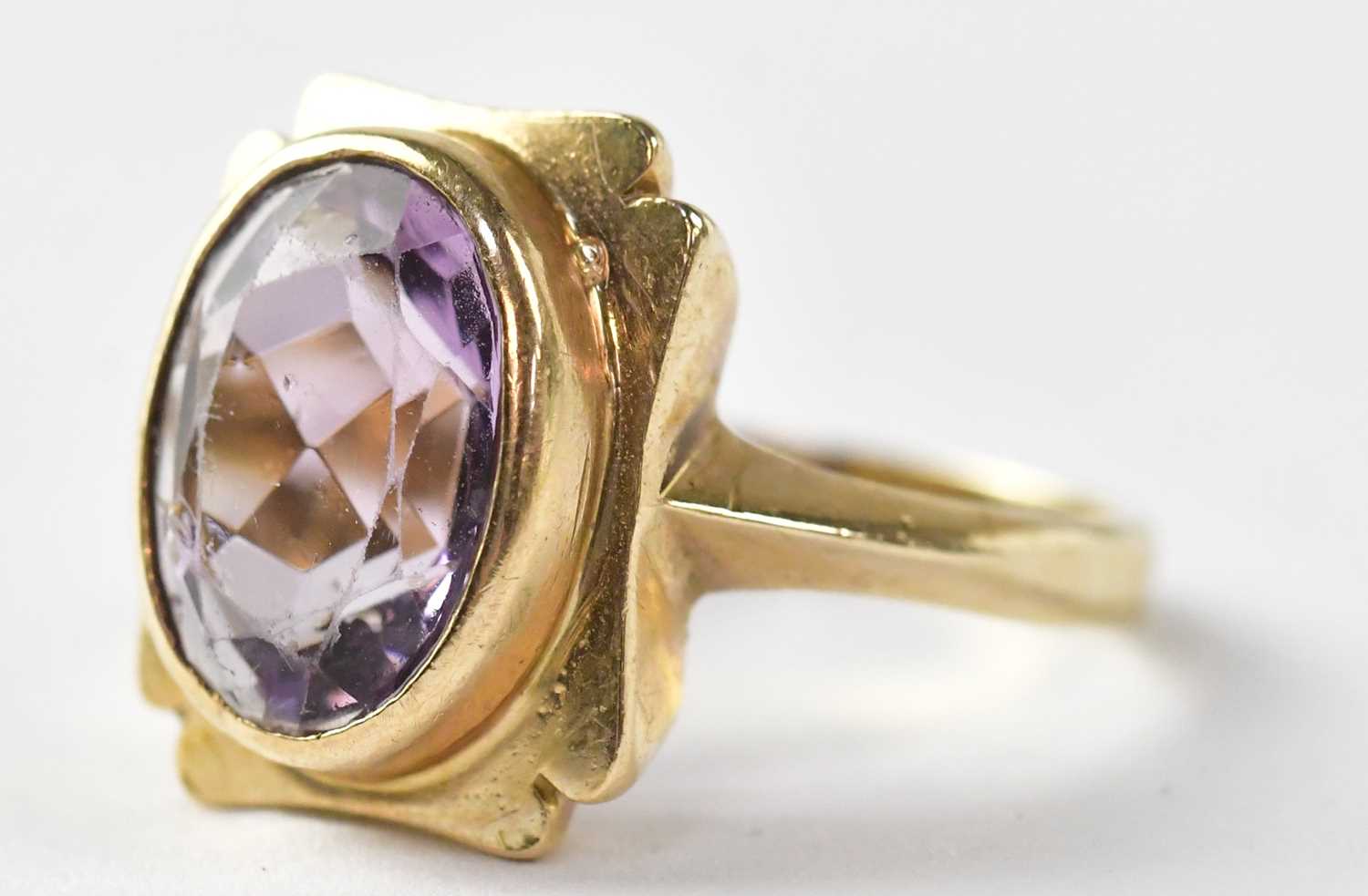 Four dress rings comprising a 9ct gold ring set with amethyst, stamped 375, size M1/2, approx. 4.6g,