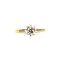 An 18ct gold solitaire ring with claw set diamond, approx. 0.6ct, to platinum shoulders, size L,