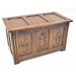 A small reproduction oak chest with panelled front and top to stile supports, 48 x 62 x 43cm.