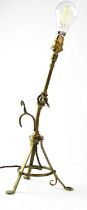 An unusual brass articulated reading lamp with tripod base doubling as a wall mounting hook,