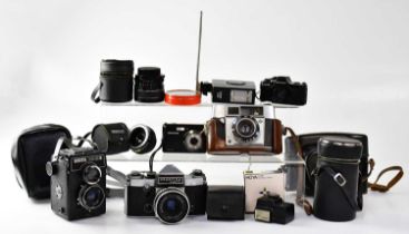 Five cameras comprising a Praktica Super TL camera fitted with a Carl Zeiss Jena Tessar 2,8/50 lens,