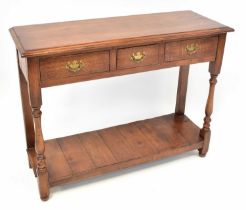 A reproduction oak side table with three drawers, to turned supports and undershelf, 74 x 100 x