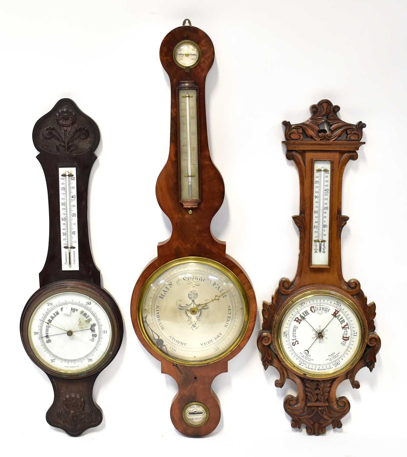 Two carved Victorian barometer/thermometers and an Edwardian example (3). Condition Report: - Please