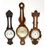 Two carved Victorian barometer/thermometers and an Edwardian example (3). Condition Report: - Please