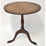 A Georgian-style oak circular tilt-top occasional table on a tripod base, with label underneath '