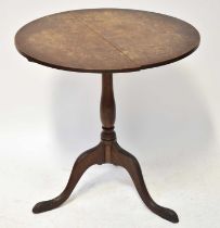 A Georgian-style oak circular tilt-top occasional table on a tripod base, with label underneath '