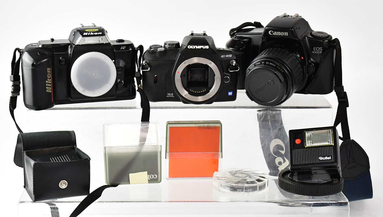 Three 35mm camera bodies comprising a Nikon F-401, a Canon EOS 1000f and a Nikon F70, together