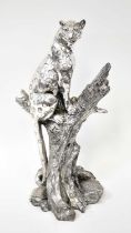 A large chromed resin figure of a leopard sitting on a tree stump, unsigned, height 50cm.