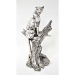 A large chromed resin figure of a leopard sitting on a tree stump, unsigned, height 50cm.