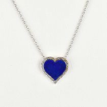 A Spanish gold heart-shaped pendant set with central lapis lazuli within a border of tiny chip